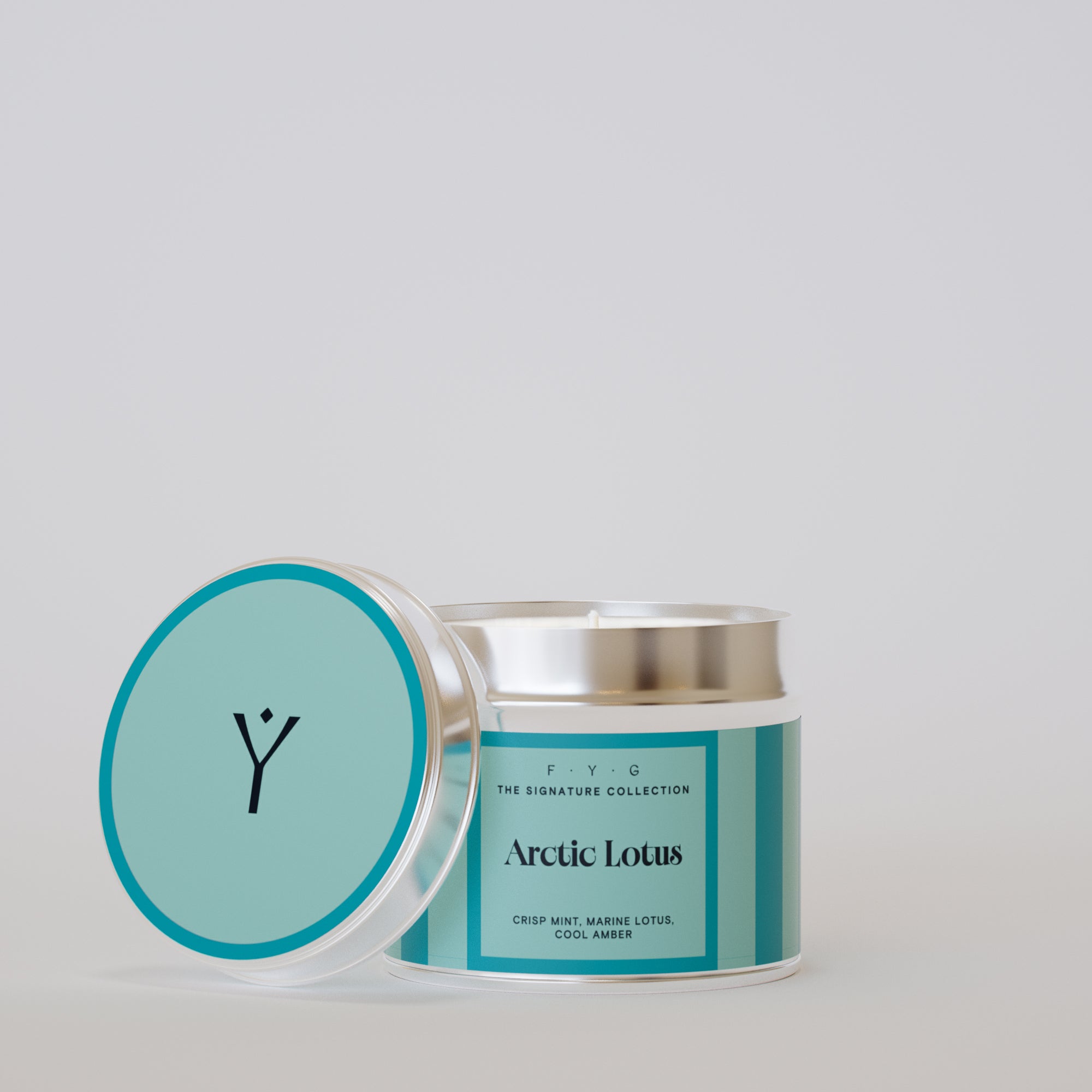 Arctic Lotus 175g tin candle open with silver lid beside it