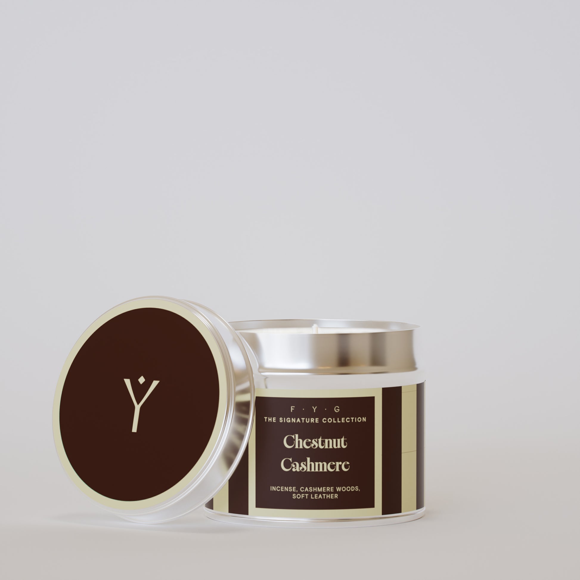 Chestnut Cashmere 175g tin candle open with silver lid beside it