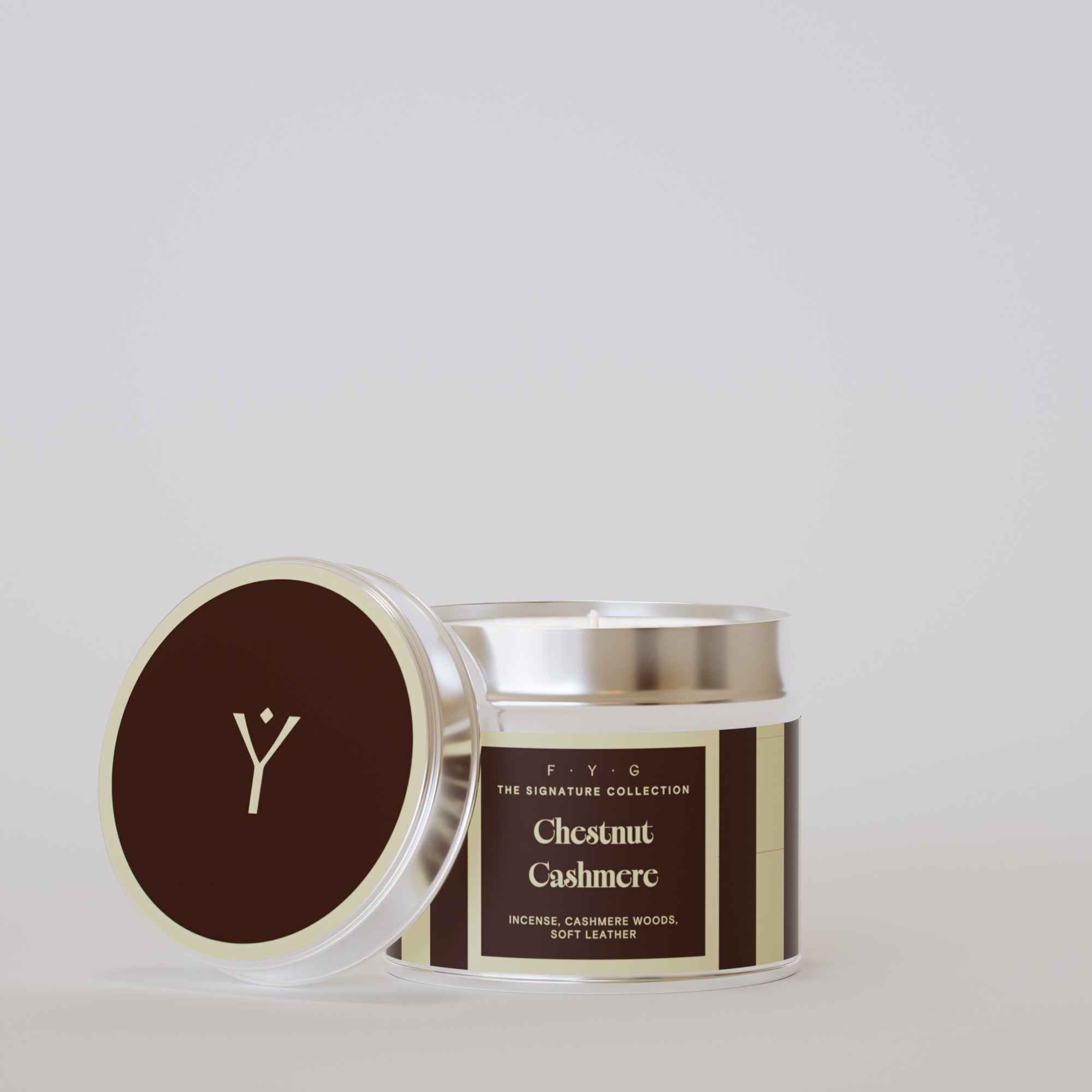 Chestnut Cashmere 175g tin candle open with silver lid beside it