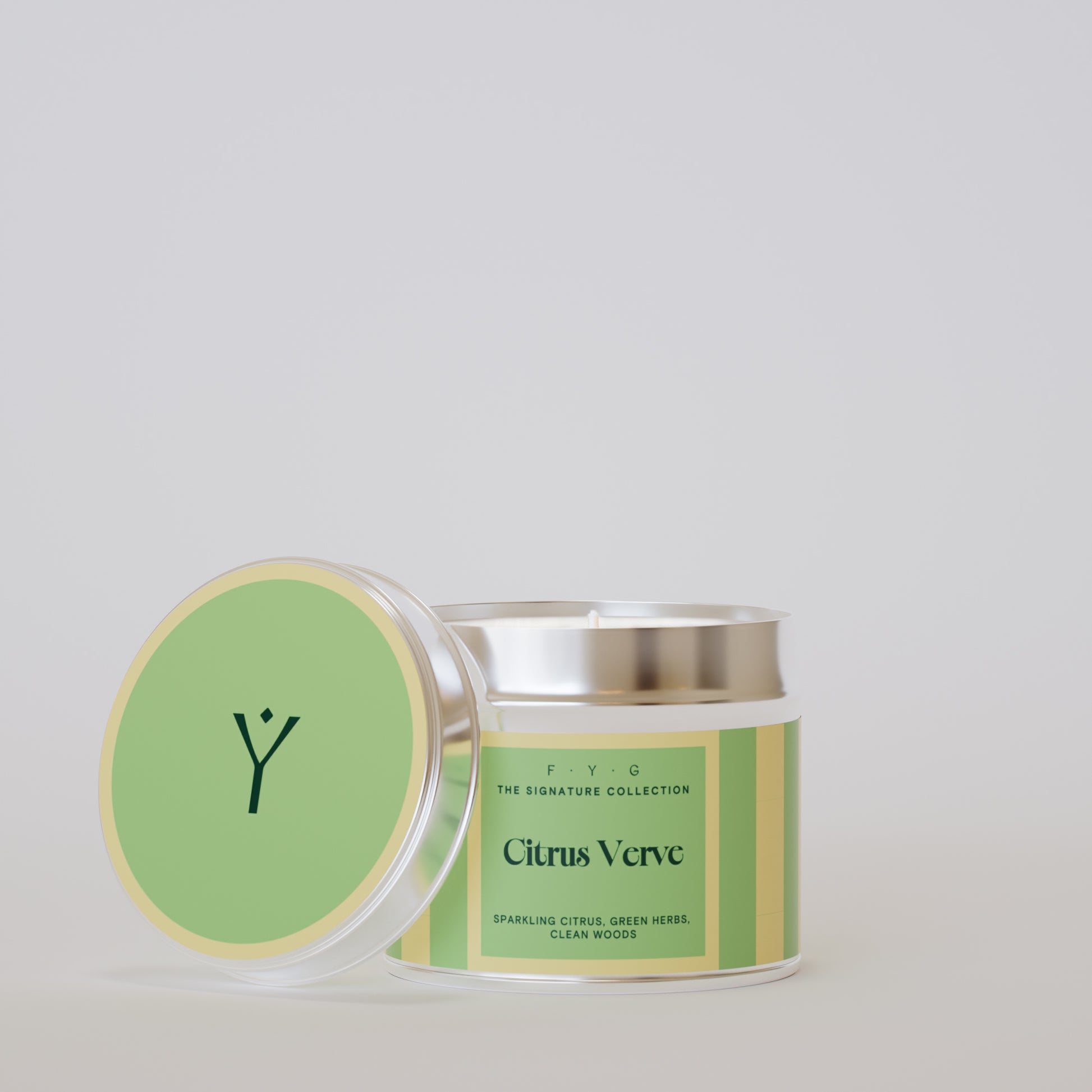 Citrus Verve 175g tin candle open with silver lid beside it