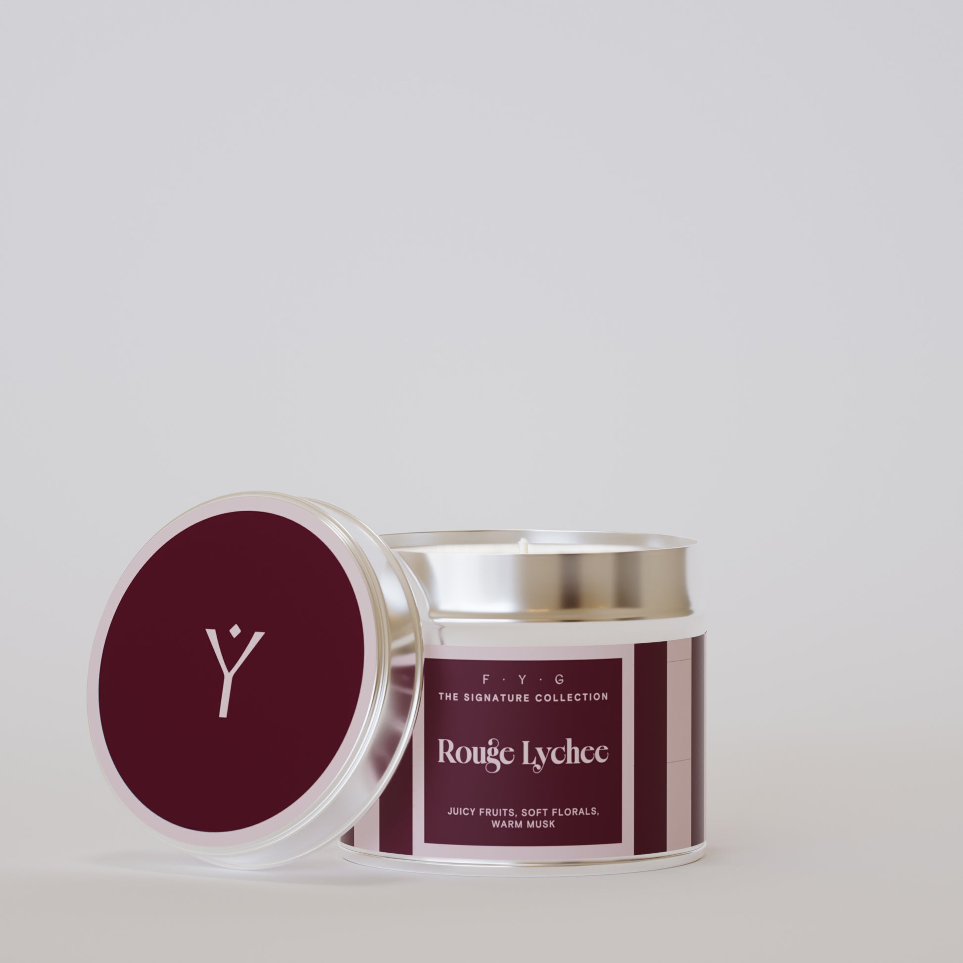 Rouge Lychee 175g tin candle open with silver lid beside it